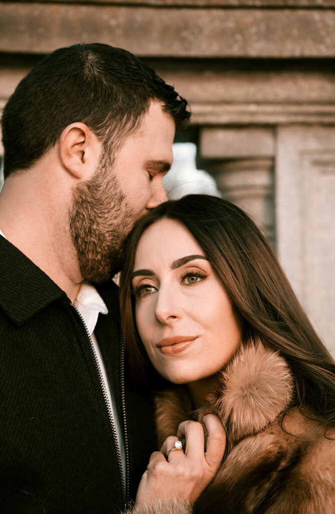 Man kisses woman during their engagement at Highland Park in Pittsburgh