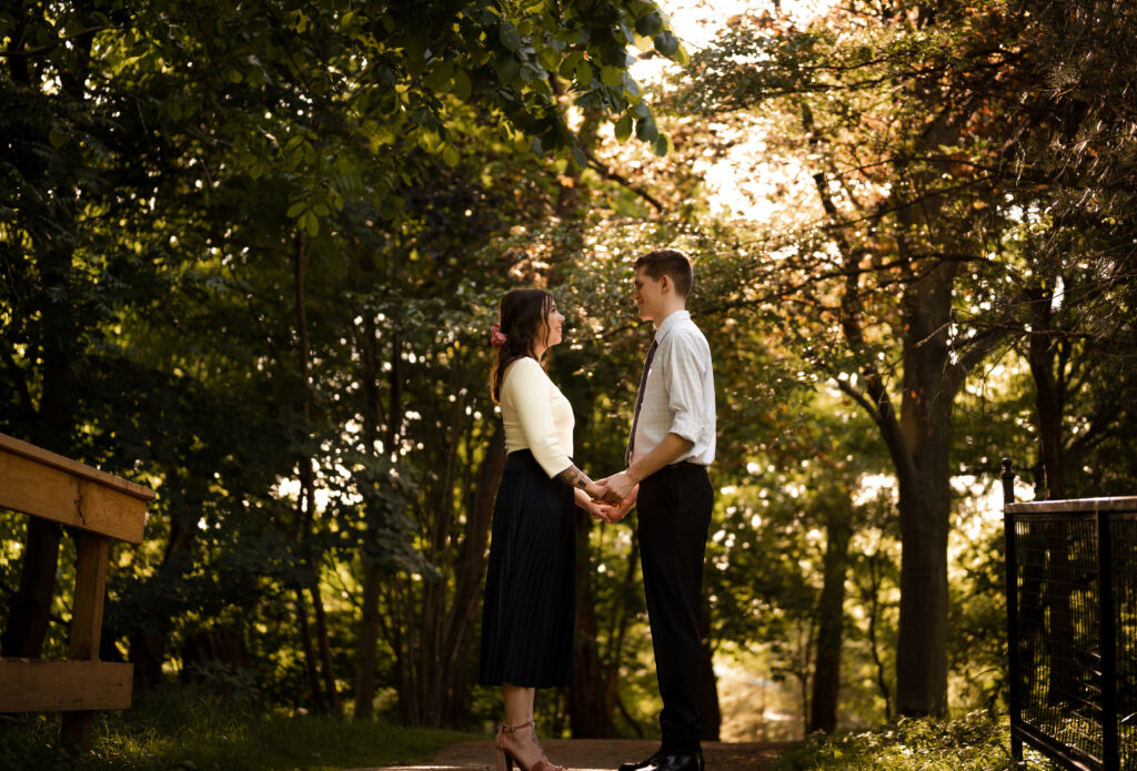 Couple facing each other during their engagement at Frick Park in Pittsburgh