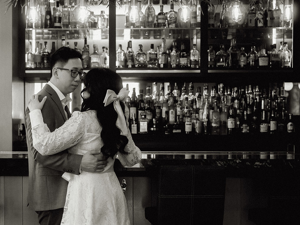 Couple looking at each other at Spirits and Tales Bar for their engagement in Oaklander Hotel