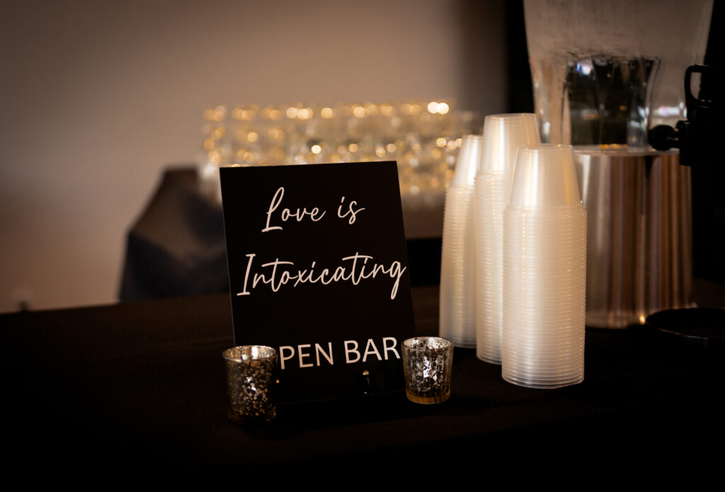 Bar photo with a sign that reads, Love is intoxicating. 