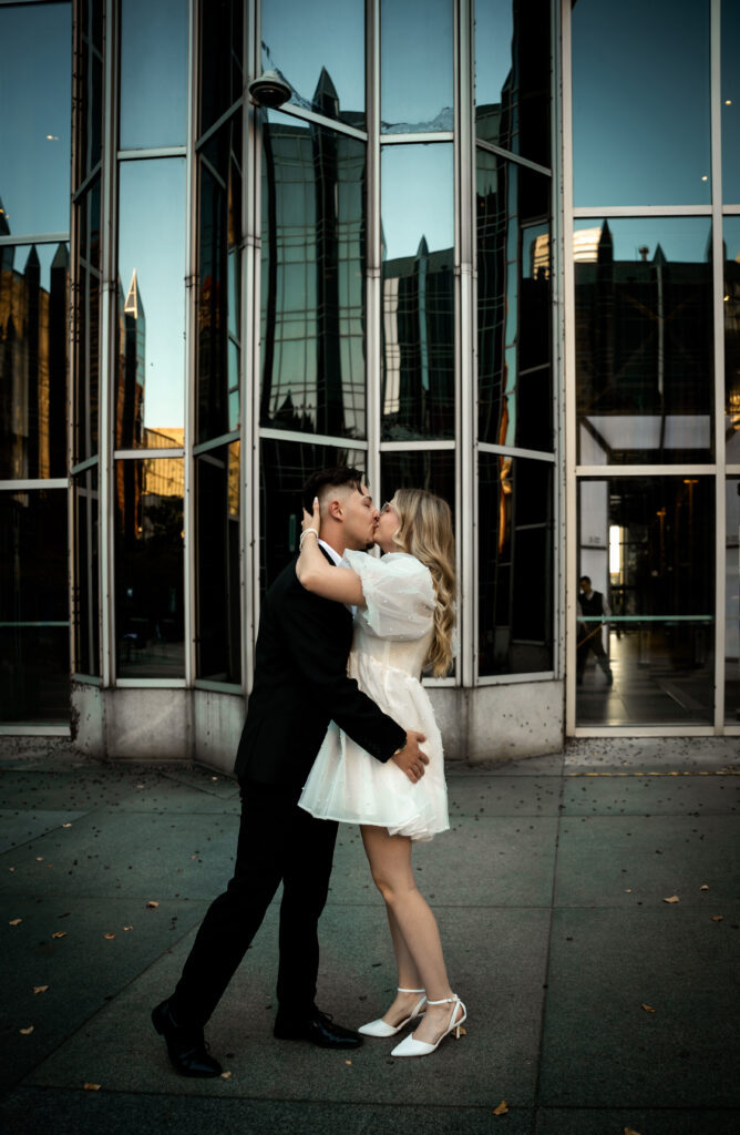 Couple kissing in front of PPG Place in Pittsburgh