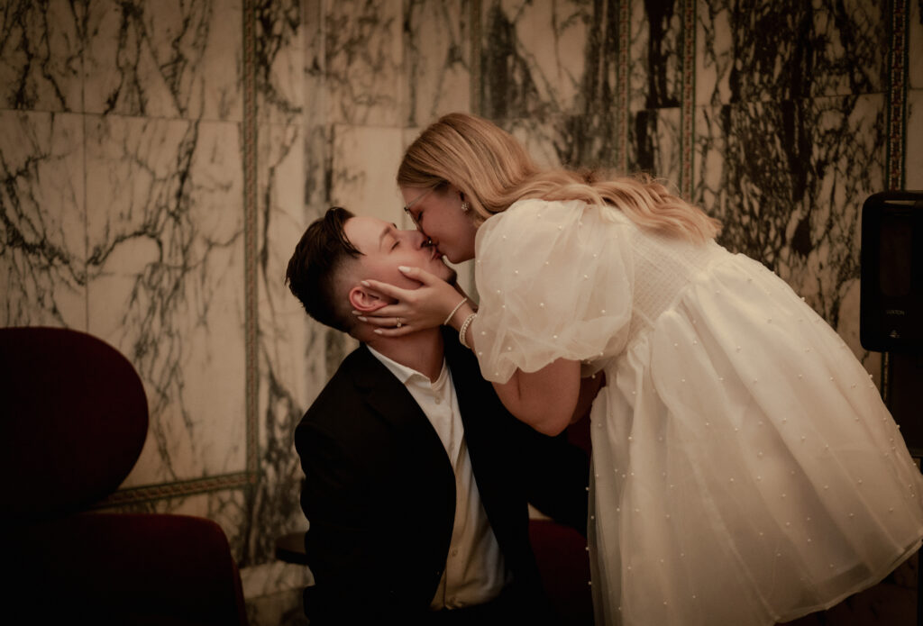 Bride kisses the Groom at the lobby of The Industrialist Hotel, Pittsburgh, Autograph Collection