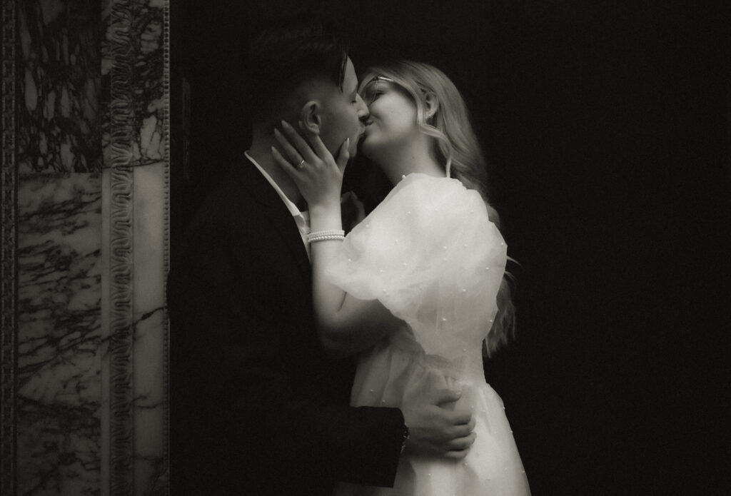 Black and white photo of couple kissing
