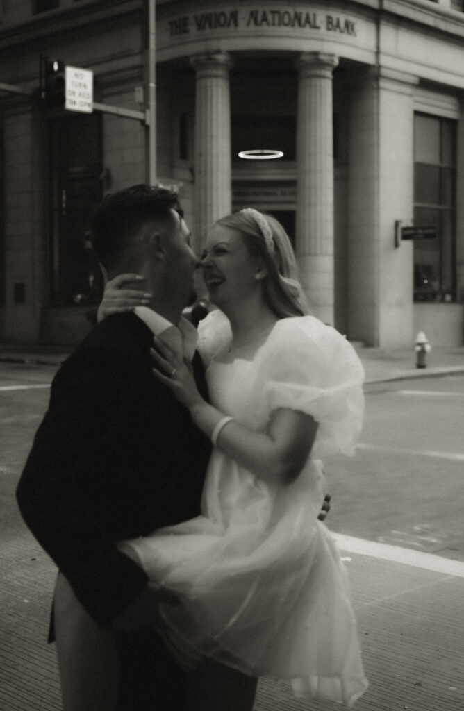 Vintage Black and White Photo of Couple Kissing in Downtown