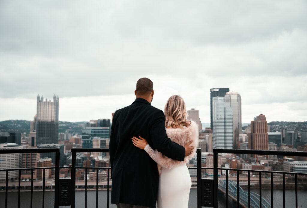 Bride and Groom Looking at the city of Pittsburgh from Grandview Overlook.
