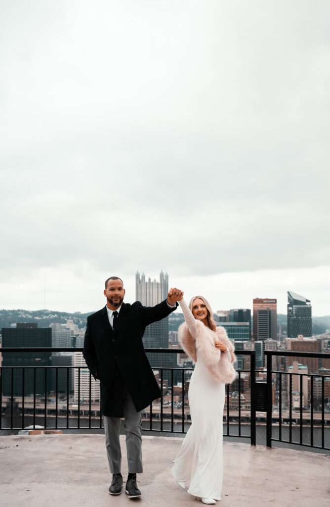 Couple walking while holding hands in Mt. Washington at Pittsburgh Grandview Overlook