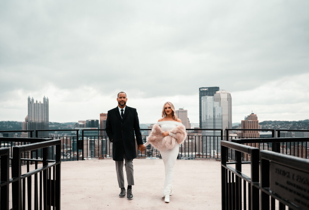 Bride and Groom walking while holding hands in Mt. Washington at Pittsburgh Grandview Overlook