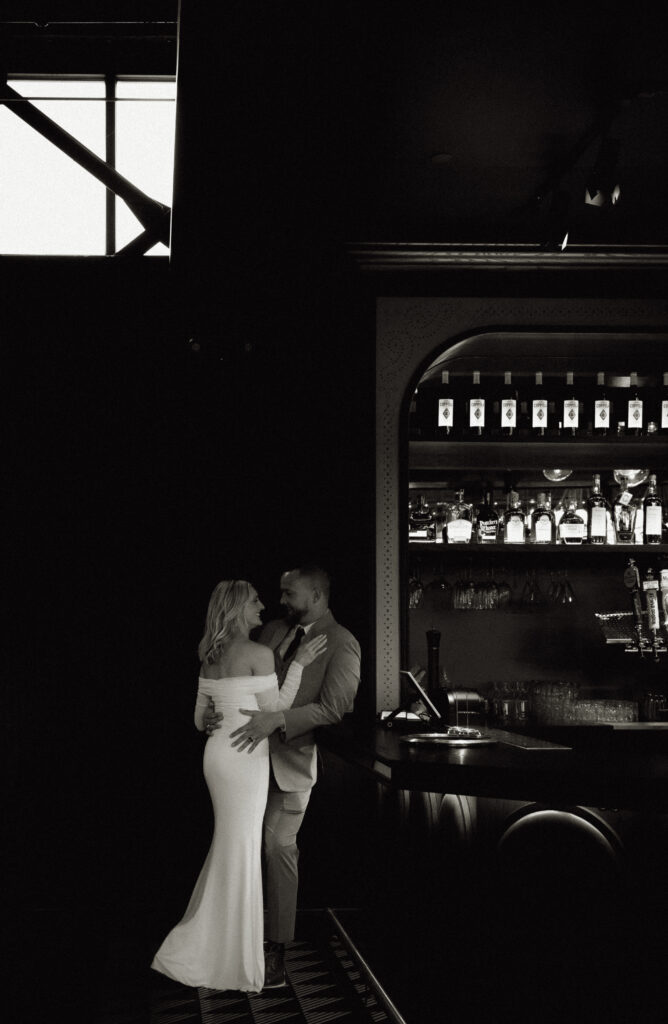 Bride and Groom looking at each other by the bar of Puttshack in Pittsburgh