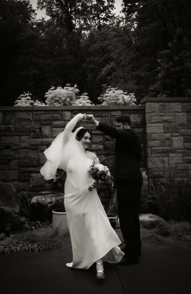 Bride and Groom Dancing at Bride and Groom standing with umbrellas and an officiant at Pittsburgh Botanic Garden