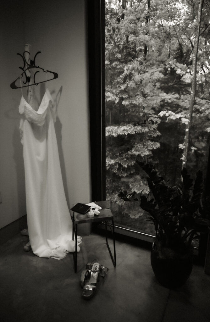 Wedding Gown Hanging off a hanger with shoes and engagement ring