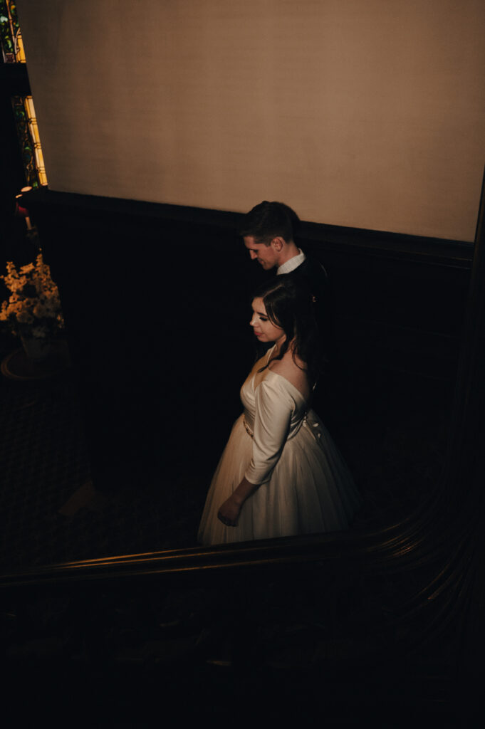 Bride and Groom coming down the staircase at The Mansion On Fifth Luxury Hotel