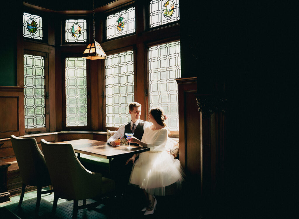 Couple sitting at The Mansion On Fifth Luxury Hotel Restaurant having a drink after wedding ceremony