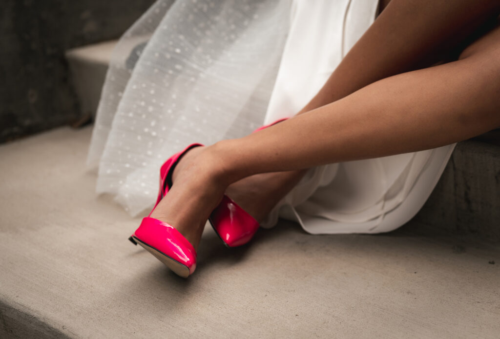Bride pink pumps with veil in the background