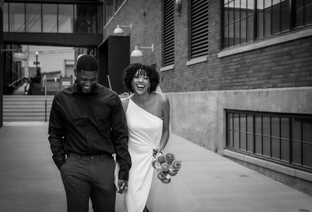 Black and White wedding Walking and laughing as they hold hands