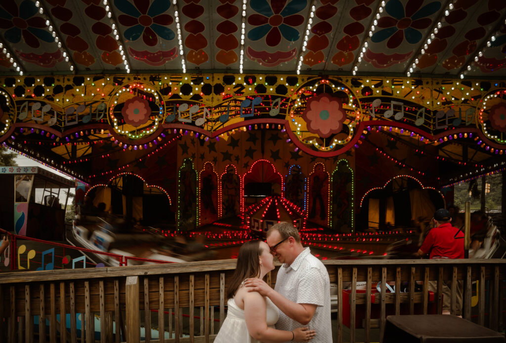 Couple kiss in front of the music express in Kennywood