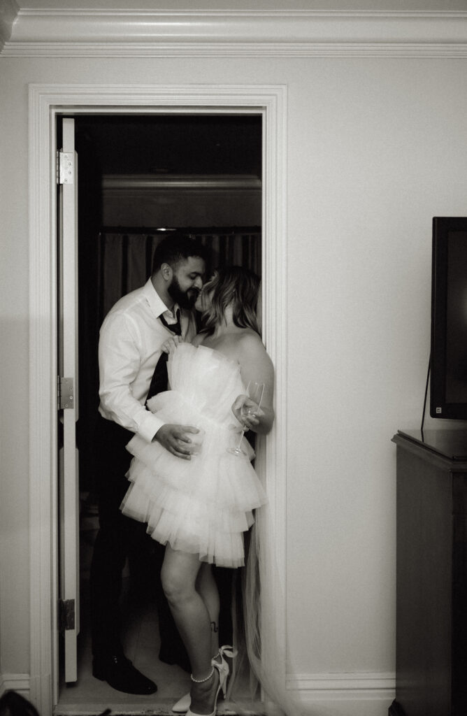 couple kissing at the entrance of the bathroom of the bathroom