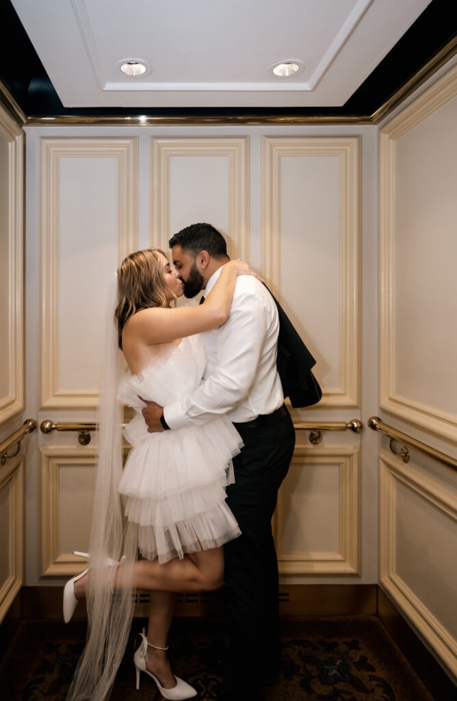 Bride and Groom kissing inside an elevator