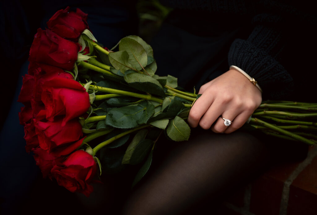 Red roses with engagement ring
