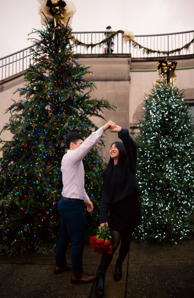Couple dancing in front of Christmas trees at Phipps Conservatory and Botanic Gardens