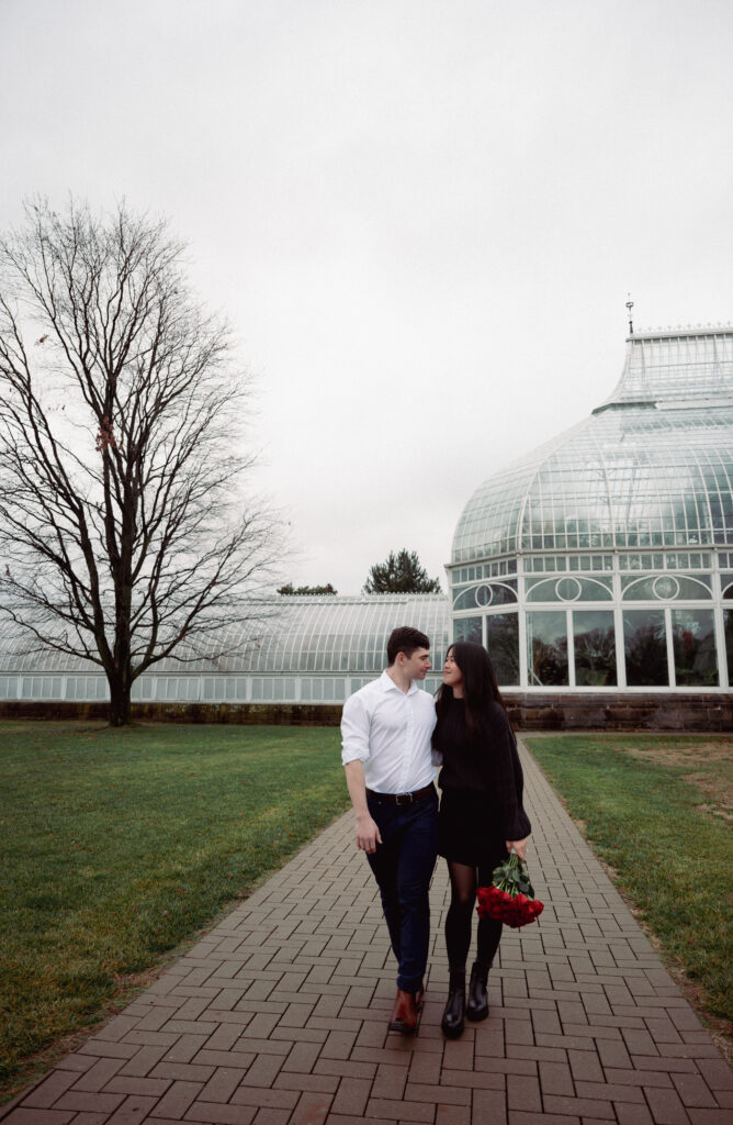 Couple walking outside of Phipps Glass building