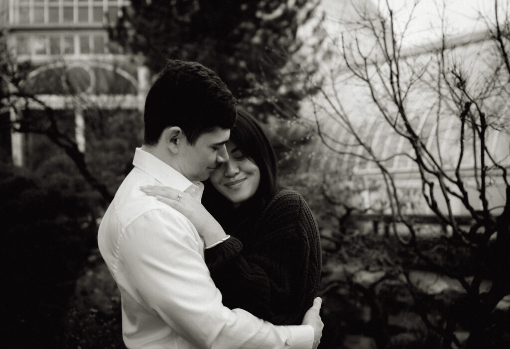 Black and white couple embracing each other at Phipps Conservatory and Botanical Garden