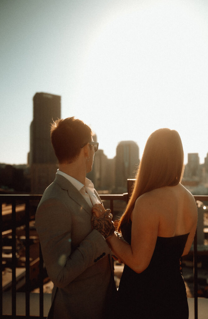 Couple holding hands while looking at Downtown Pittsburgh