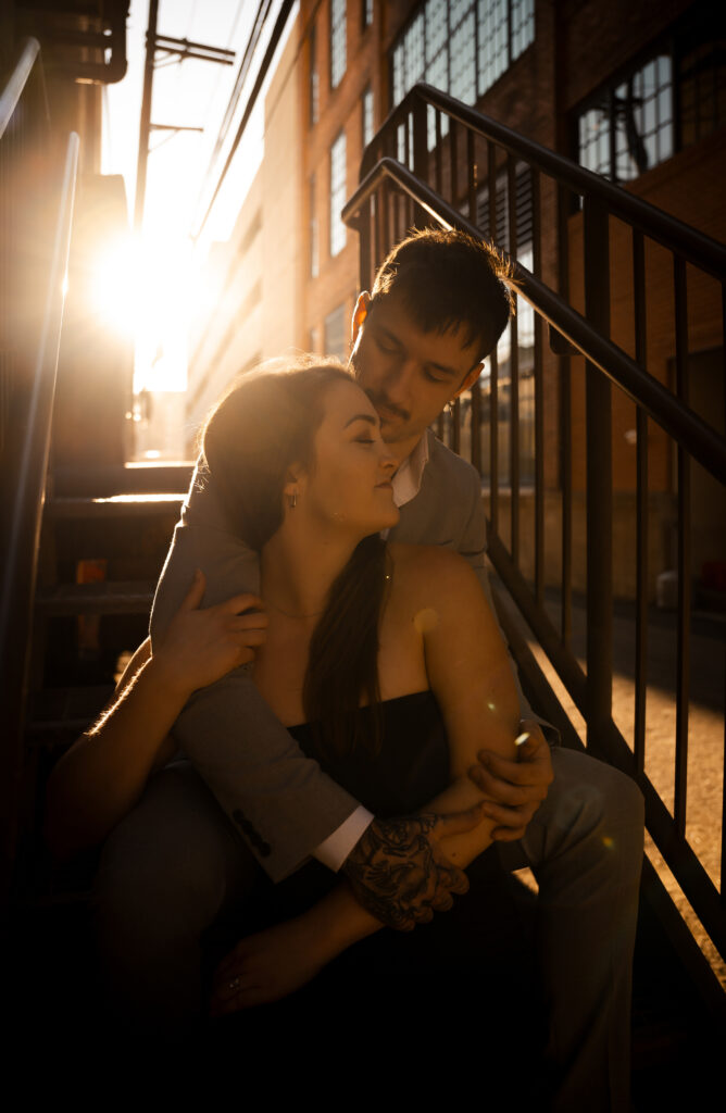 Artistic engagement photos with couple leaning against urban brick walls in the Strip District