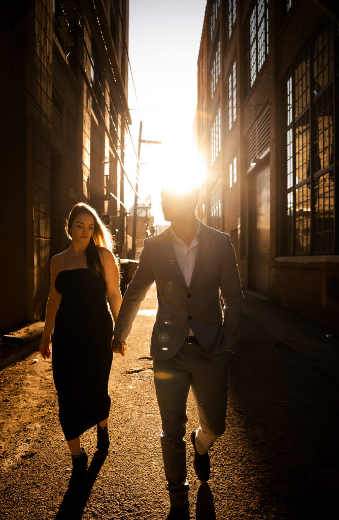 Couple walking down in Pittsburgh Strip District during golden hour