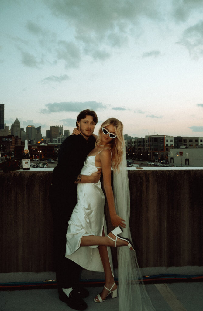 Bride and Groom in rooftop overlooking Downtown Pittsburgh