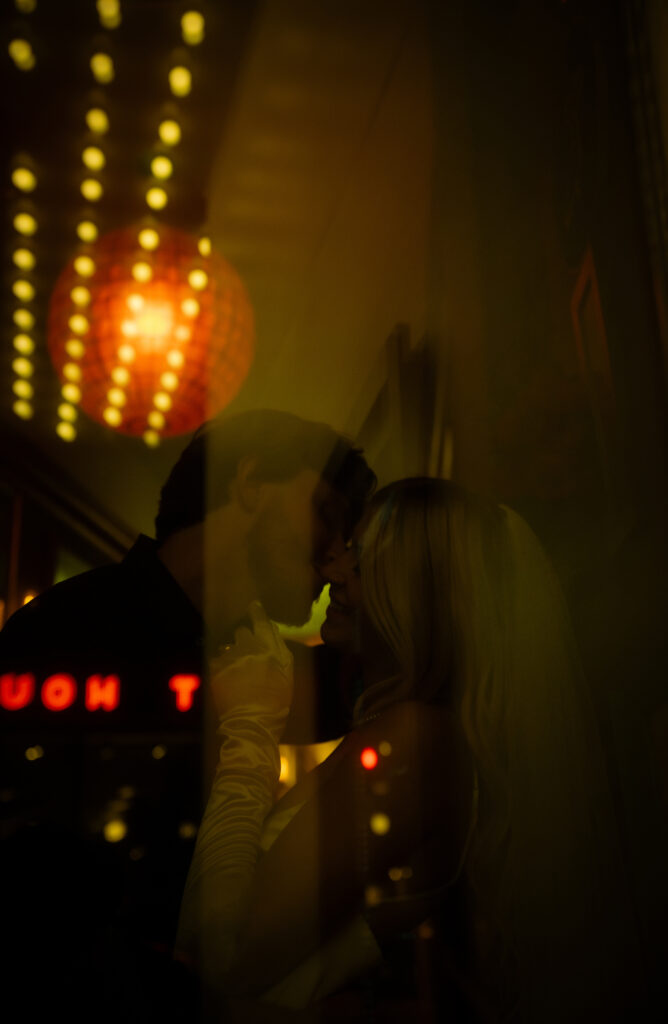 Reflection of Bride and groom about to kiss at Row House Cinema in Pittsburgh