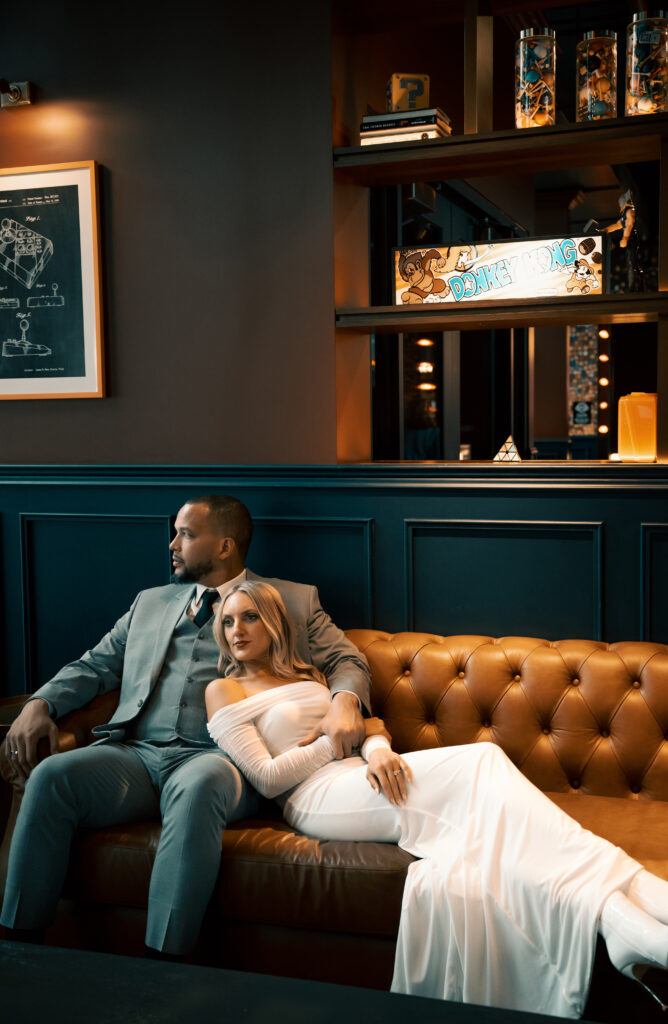 Bride and Groom sit in a sofa at Strip District Restaurant 