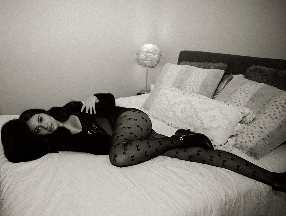 Intimate photo of a woman wearing lingerie laying down on a bed