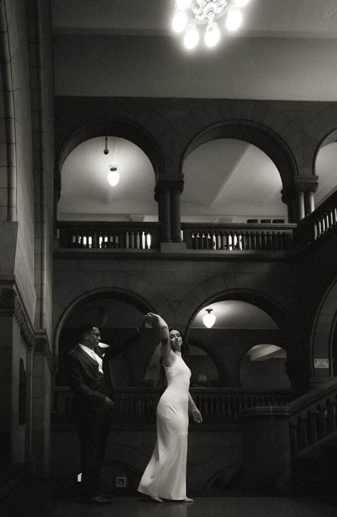 Groom spins bride at the Allegheny Courthouse after their wedding in Downtown Pittsburgh