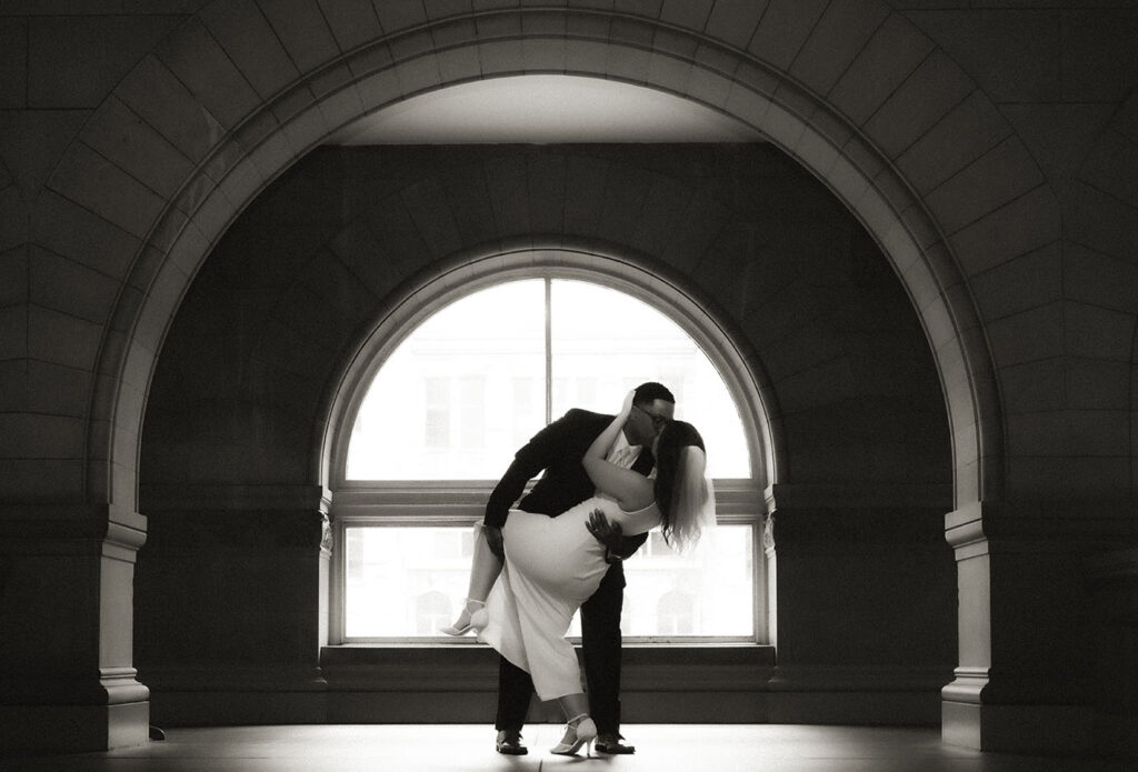 Bride and Groom kissing up in the Allegheny Courthouse after their wedding in Downtown Pittsburgh