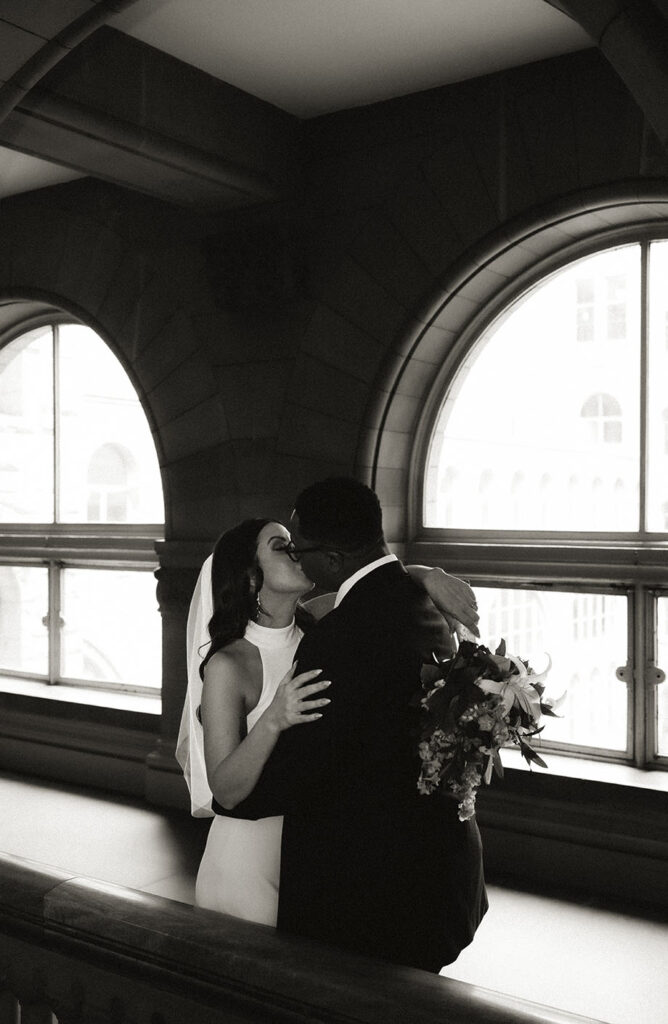 Bride and Groom kissing up in the Allegheny Courthouse after their wedding in Downtown Pittsburgh