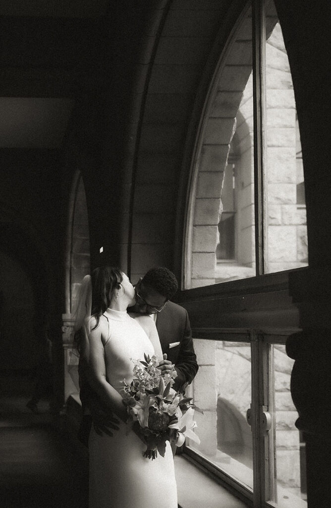 Couple kiss each other at Allegheny Courthouse after their wedding in Downtown Pittsburgh