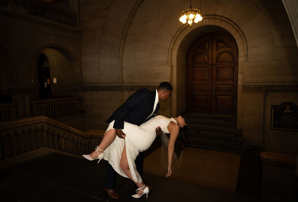 Groom Dips bride at the Allegheny Courthouse after their elopement