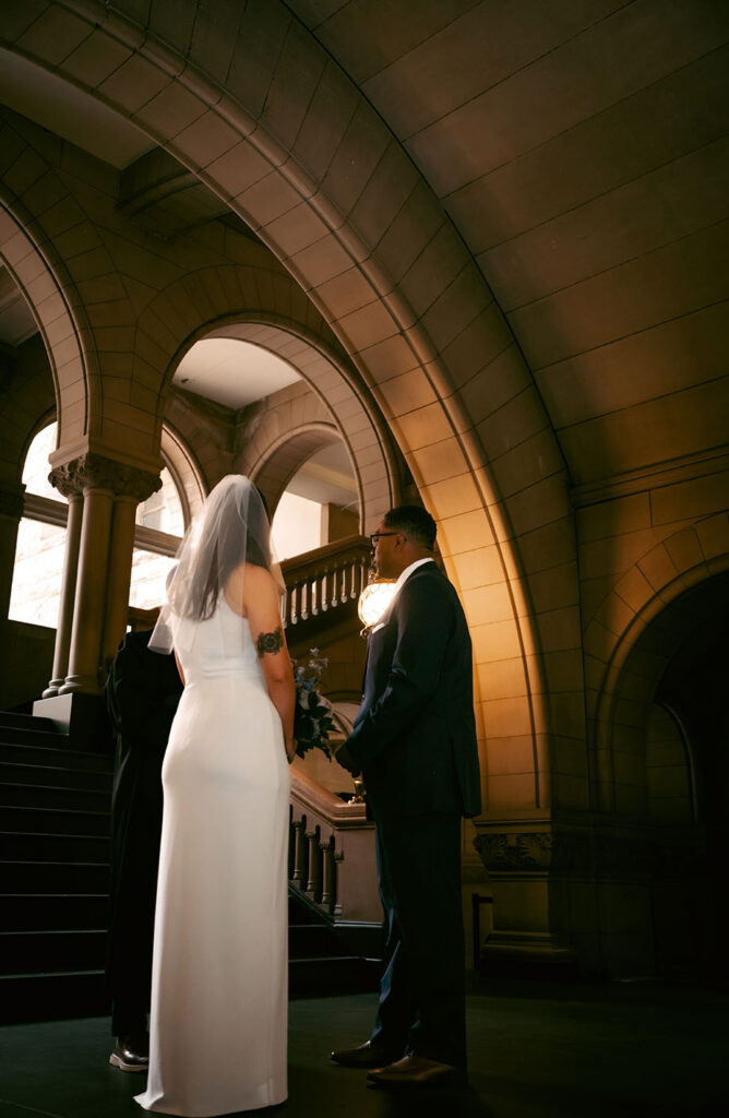 Couple facing the judge at the Allegheny Courthouse during their wedding ceremony in Downtown Pittsburgh