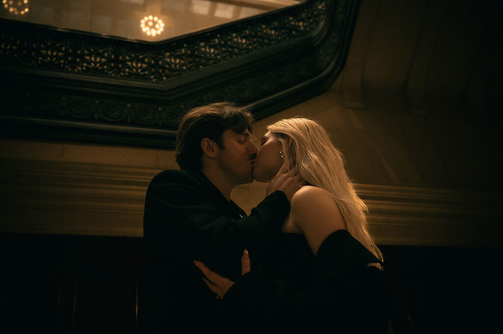 Couple kiss at their engagement in Carnegie Museum of Art
