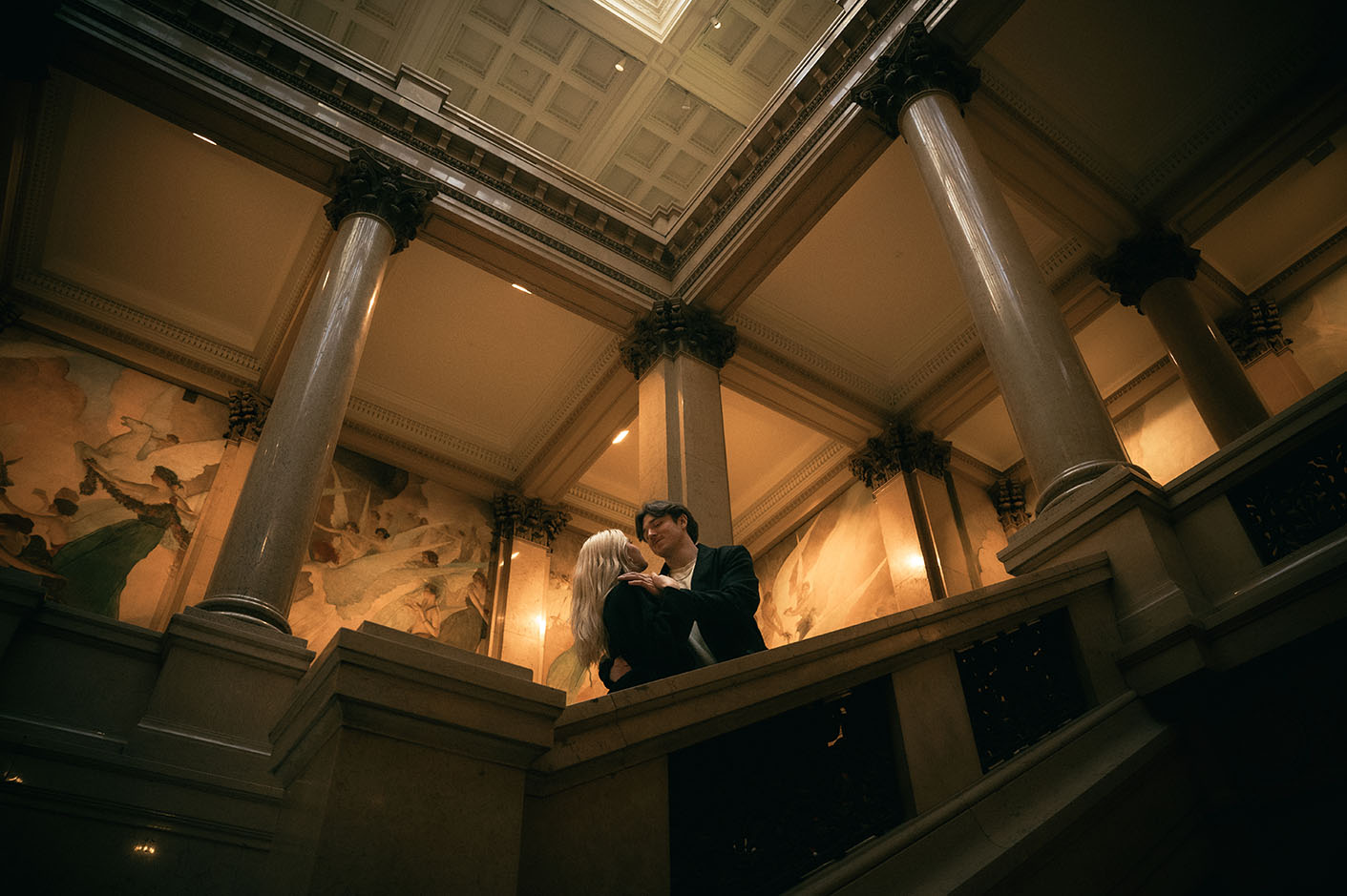 Couple looking at each other at the Grand Staircase room at Carnegie Museum of Art
