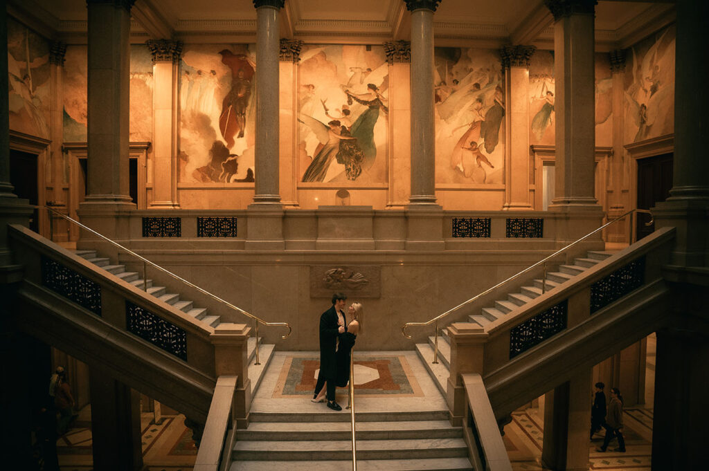 Couple stand in the grand staircase at Carnegie Museum of Art in Pittsburgh