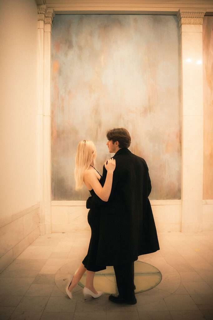 Couple facing a painting at the Hall of Sculpture in Carnegie Museum of Art in Pittsburgh