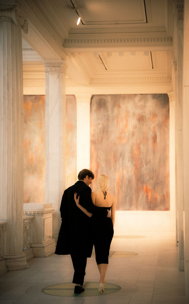 Couple walk at the Hall of Sculpture in Carnegie Museum of Art in Pittsburgh