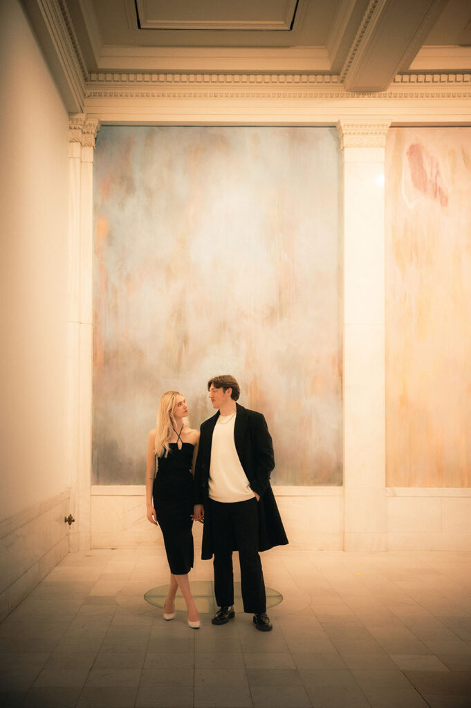 Couple stand at the Hall of Sculpture in Carnegie Museum of Art in Pittsburgh