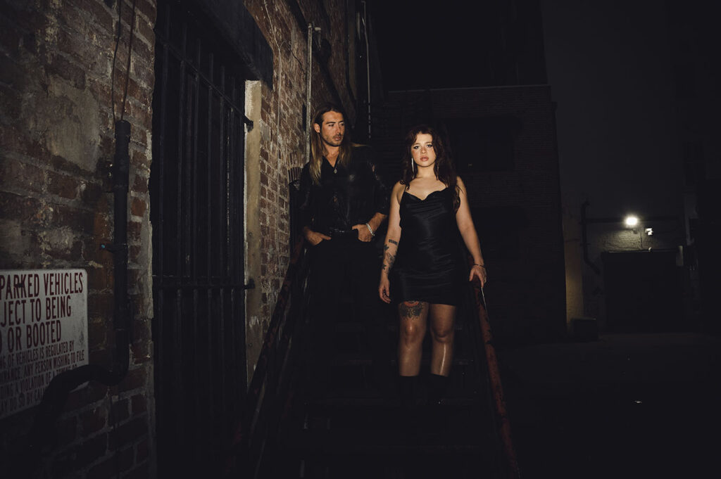 Couple standing in an alley's staircase in South Florida