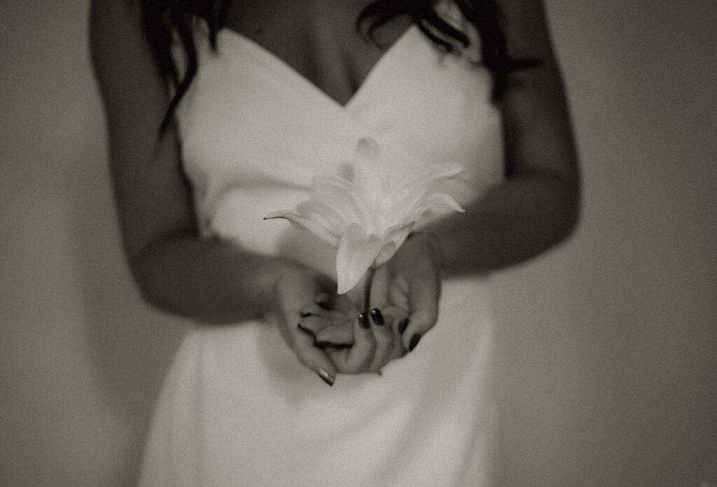 BW Bride holds a white flower