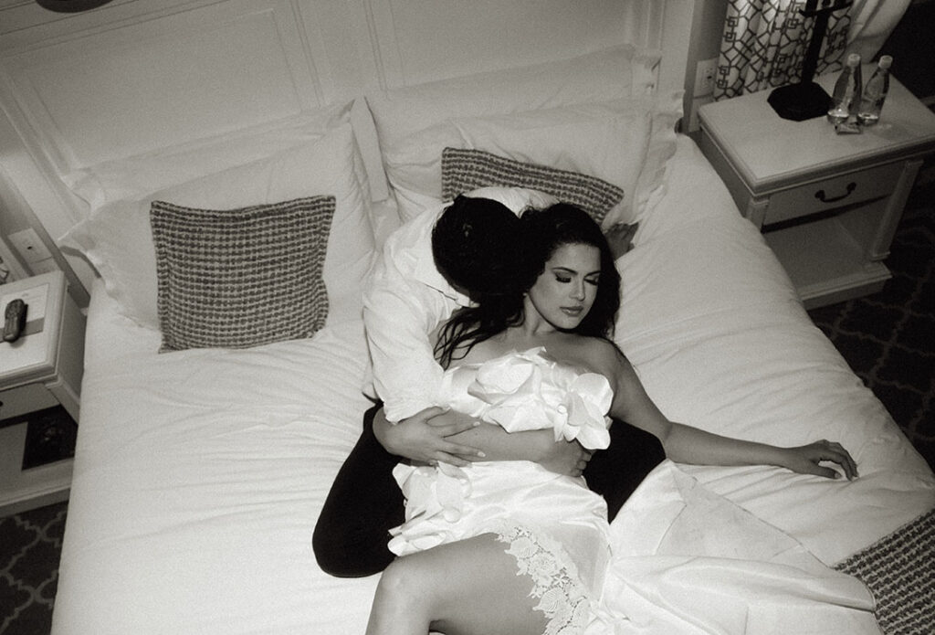 B&W Bride and Groom laying in bed before wedding