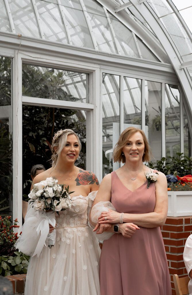 Bride and her mom walking in Broderie Room for their wedding