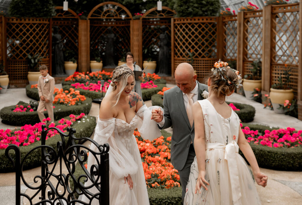 Bride and Groom walk out after their ceremony at the Broderie Room