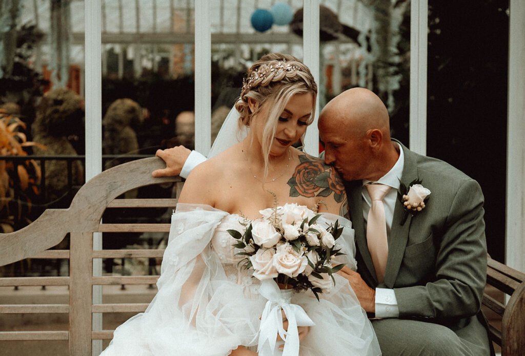 Bride and Groom Sitting in a bench at Phipps Conservatory and Botanical Gardens